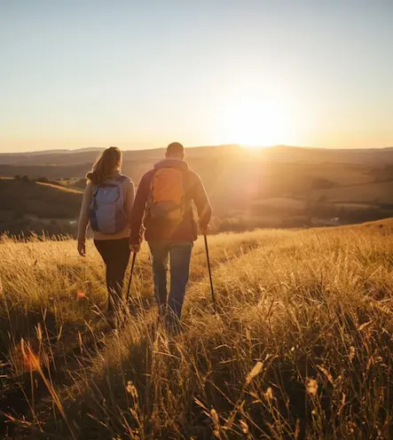 Two people walking side by side outdoors in nature